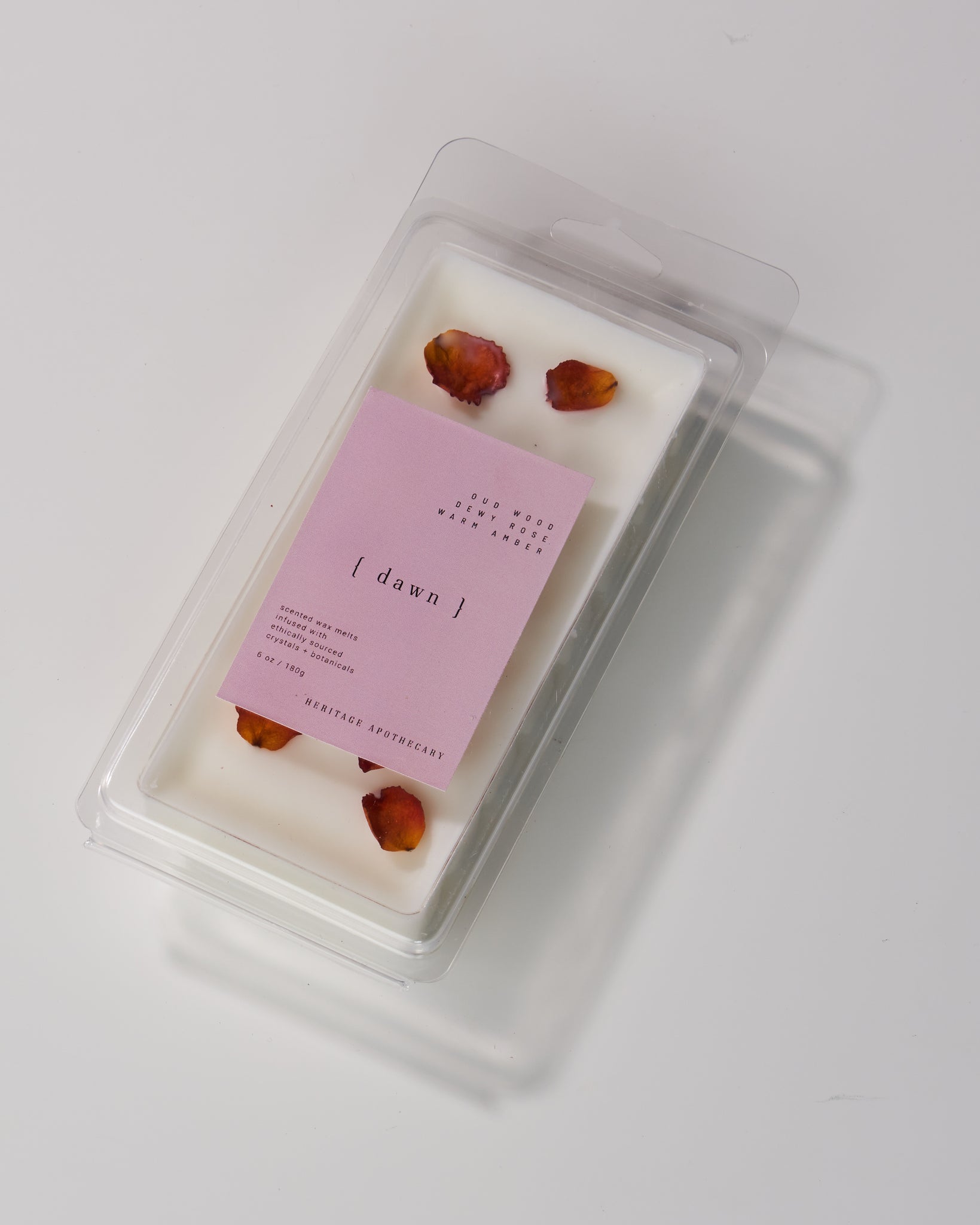 Coconut and soy wax melts in Dawn scent - a dynamic blend of cedar, amber, guaiac wood, cumin, rose, and musk. Infused with hand-picked rose petals to enhance your home's fragrance