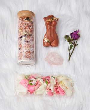 Venus Kit for spiritual cleanse and self-care. Bath Kit includes natural mineral salts, hibiscus, gold leaf flakes, rose petals, Venus candle, and rose quartz stone. Shower Kit features aromatherapeutic shower steamers with similar ingredients. Transform your bathroom into a sacred space for spiritual healing and self-discovery with this kit. Includes a Spotify playlist for the perfect ambiance