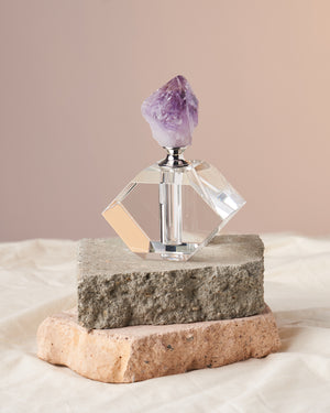 Amethyst Perfume & Essential Oil Bottle - Rose Quartz-Encrusted Home Adornment: Elevate your space with this stunning amethyst bottle, featuring a rose quartz encrusted design. Perfect for storing perfumes and essential oils. Harness the power of intuition, spiritual expansion, and protection with the raw amethyst stone. Measures 6” in height and 4” in diameter, with a capacity of approximately 1 dram (5ml) of oil. A must-have home decor and a thoughtful gift