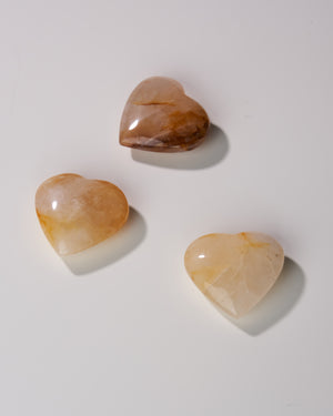 Enhance your spiritual journey with the profound energy of Golden Healer Quartz Hearts. This powerful healing stone envelops you in Universal Light, cleansing and balancing your aura while invoking clarity, wisdom, and divine creativity. Your purchase includes one tumbled Golden Healer stone, with an average size of 1x3 inches.
