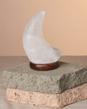Discover the beauty and benefits of our Himalayan Salt Lamp, handmade from Himalayan Pink Crystal Salt Crystals. This ionizing mineral lamp generates negative ions, naturally purifying your indoor space. It's also thought to cleanse energy in homes, offices, and more. Crafted by skilled artisans, each lamp is a unique piece. Size: approx. 5.5" tall x 3" wide, weight: approx. 1.5 lbs. Includes USB cord lighting with a color-changing bulb.