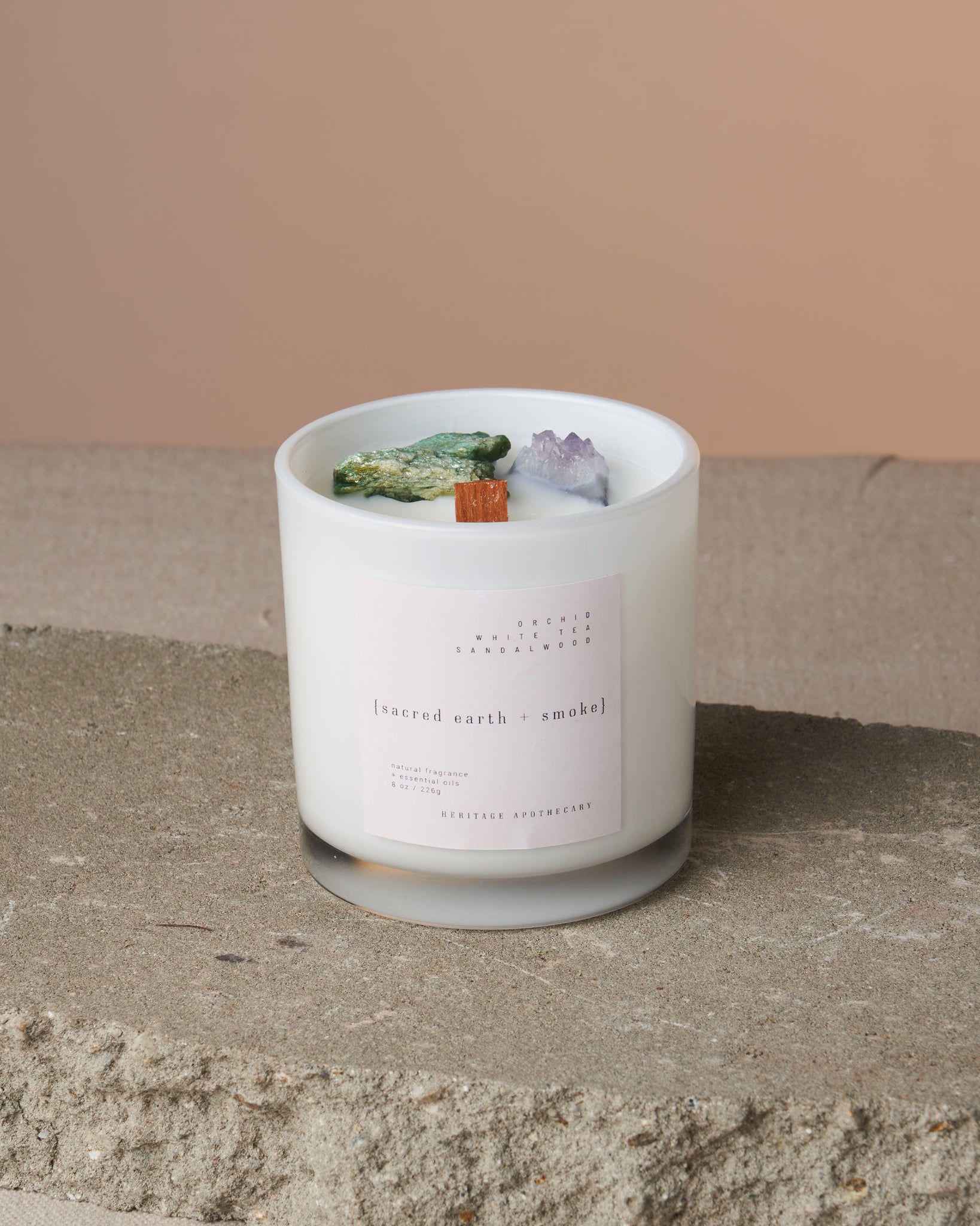 Enhance your spiritual rituals with this handcrafted coconut and fruit wax candle. Aromatic blend for the best guided meditation experience. Contains amethyst and fuschite crystals for ancestral healing and connection to nature.