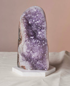 Amethyst lamps known for tranquility, clarity, and spiritual development. Ideal for home or office decor and great gifts. Soft glow for healing vibes. Included: polished amethyst lamp and electric tealight bulb. Sizes: Medium (4-6”), Large (7-10”), XL (8-14”). Natural variations in size