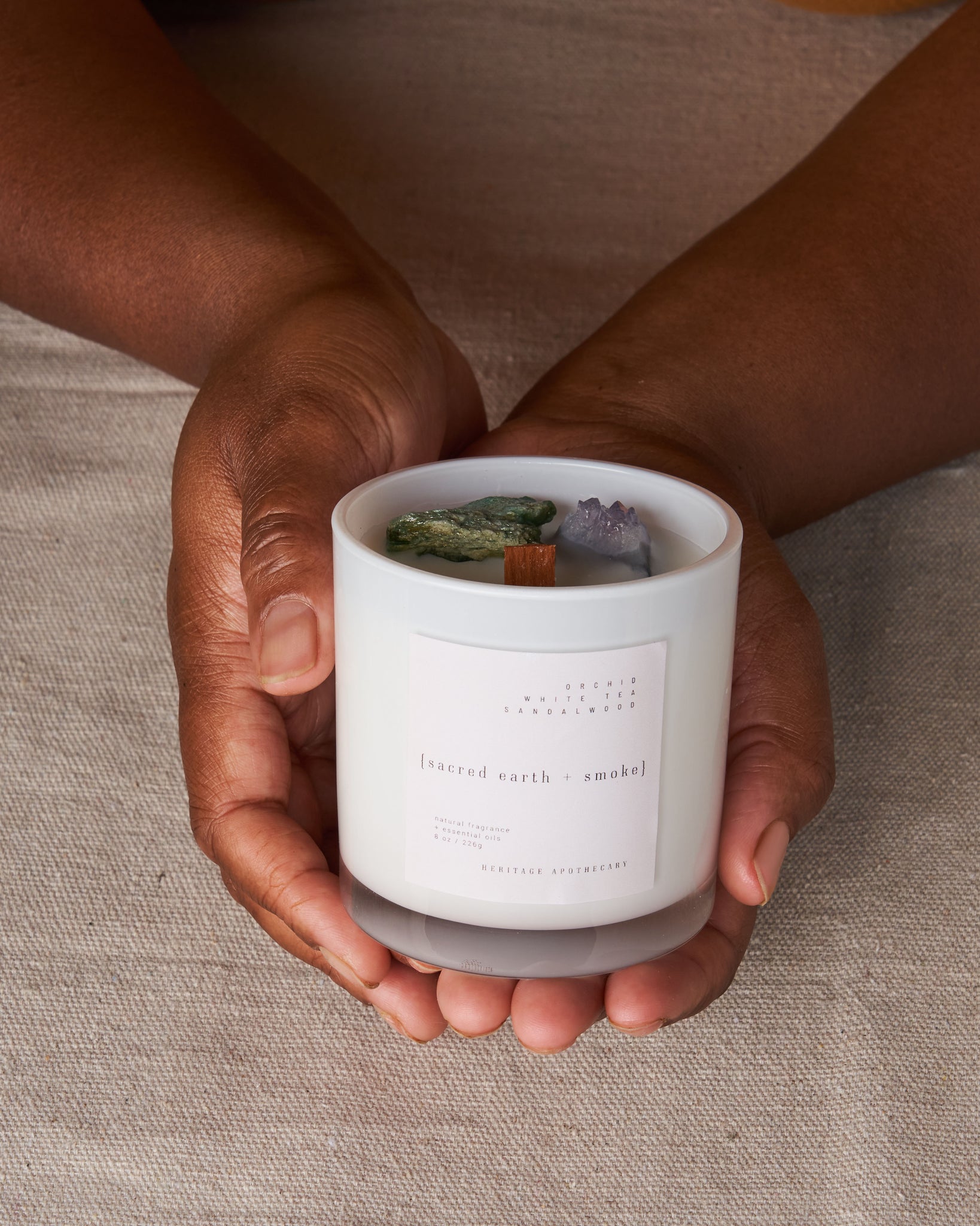 Luxurious coconut and fruit wax candle, perfect for guided mindfulness meditation. Scented with saffron, white tea, and vanilla. Features amethyst and fuschite crystals for spiritual connection and holistic wellness.